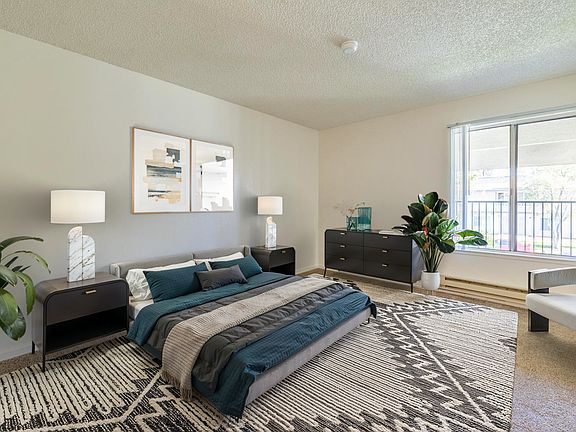 Spacious bedroom with lots of natural light and modern accents.