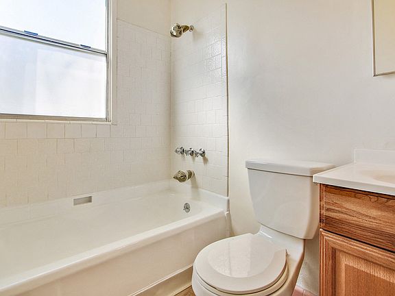 Bathroom With Tub and Shower Combo, Wood Style Flooring