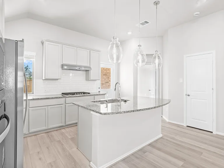 Spa-like primary bath with soaking tub, separate glass-enclosed shower, double vanity, and direct access to the walk-in closet.