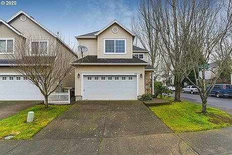 Front of home with 2 car garage and parking driveway.
