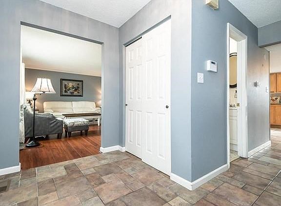 Ceramic tile entry opens to living room on the left.