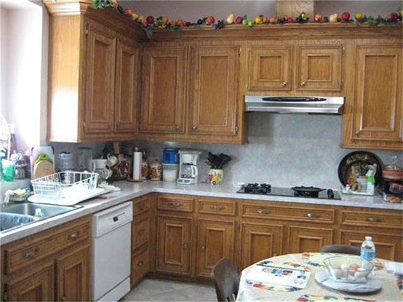 Kitchen overlooks backyard/pond.