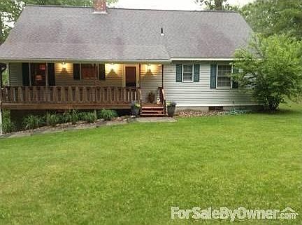 Deck wraps around the side of the house to entry door