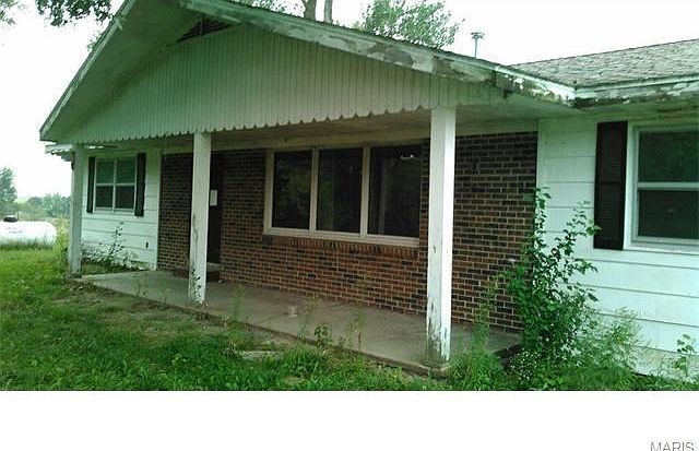 Entrance to home with covered porch.