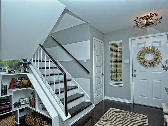 Stairwell, built in bookshelves, and coat closet