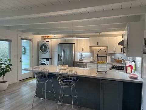 Kitchen showing in-unit washer and dryer