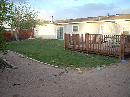 Backyard - deck, lawn, swingset, all fenced in