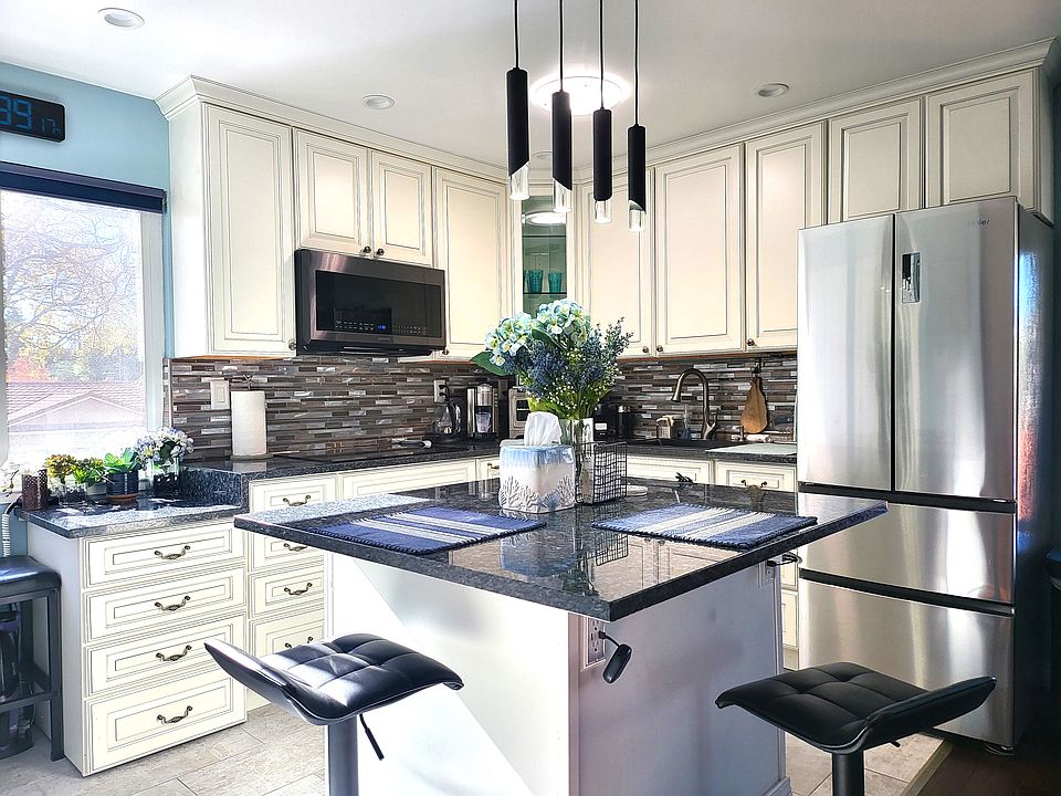 Updated kitchen fully furnished with appliances and household items.