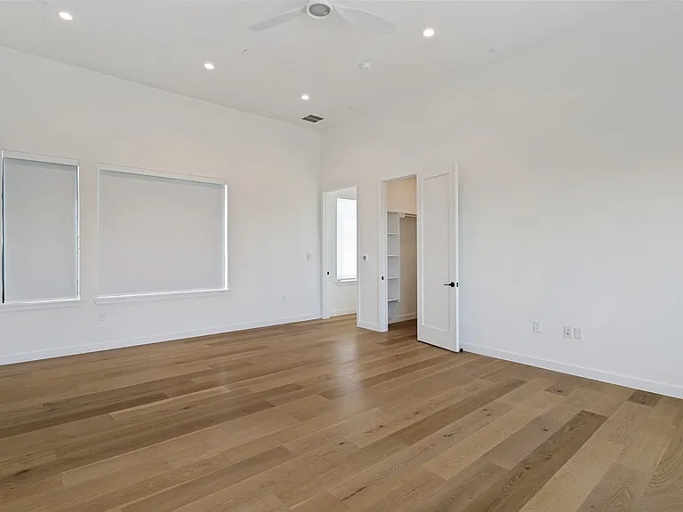 Second primary bedroom with en suite full bathroom and walk in closet. This space would be perfect for multi-generational or game/media room! Has access to deck with pergola. (3rd floor)