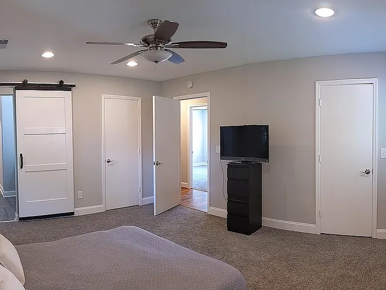 primary suite with two walk in closets