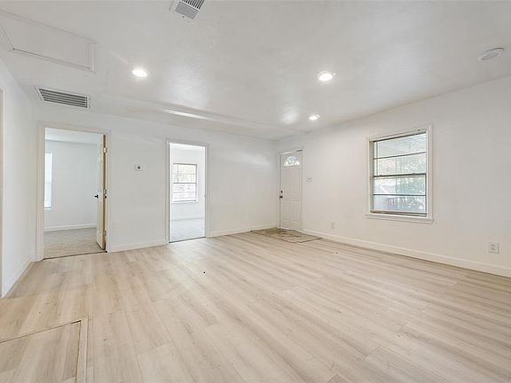 Unfurnished room with recessed lighting, visible vents, and a healthy amount of sunlight