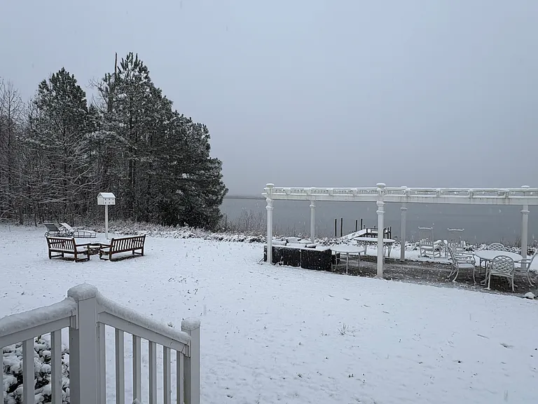 The river view in the snow - pergola, birdhouse and firepit.