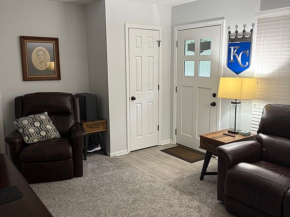 Living Room with view of Front door and coat closet. New doors, carpeting, blinds and fresh paint throughout.