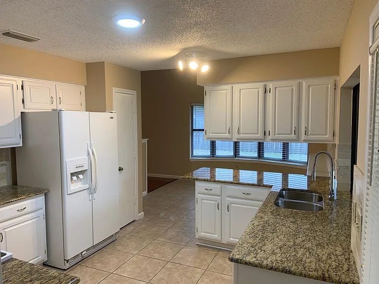 KItchen view overlooking breakfast area with bay windows
