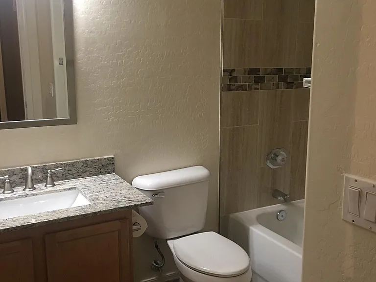 Guest bathroom with Granite Counter tops, new mirror, lights.