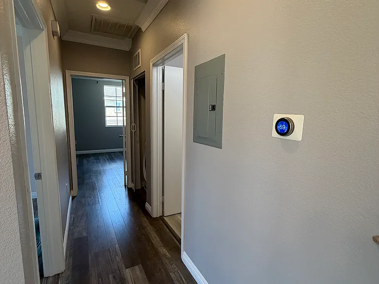 Hallway with Nest smart thermostat.