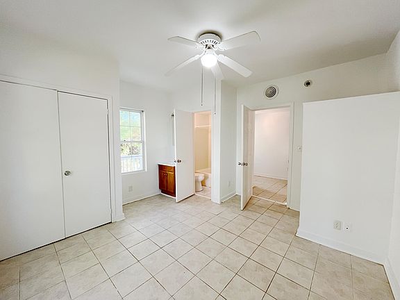 Bedroom 2 is on the front side of apartment near main entry door. Full size closet on left. Full bathroom in the middle background of picture. Please not the sink is inside the bedroom just to the right of window.