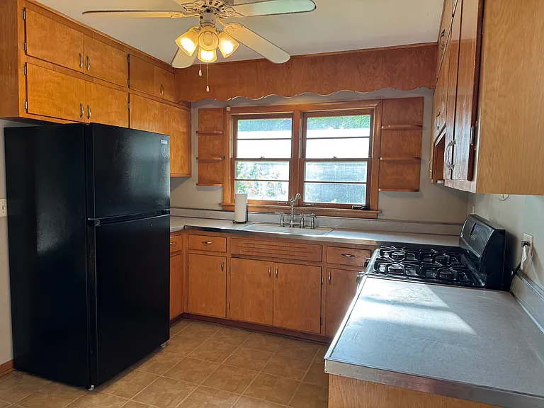Kitchen with newer refrigerator and stove.