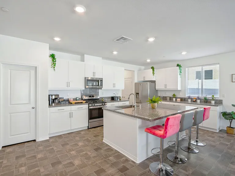 The kitchen and kitchenette are equipped with essential cooking tools, including a gas stove, coffee machine, microwave, fridge, and dishwasher.