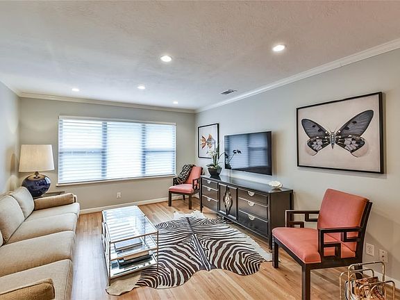 The classic front living area of this impressive home features custom Hunter Douglas window coverings and  quarter sawn oak floors.