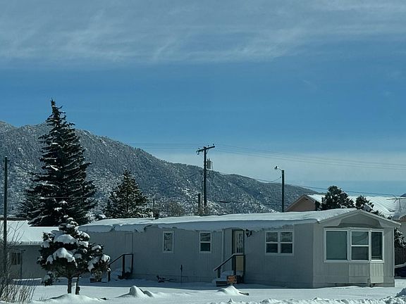 Front Elevation in the winter facing southeast with Eastridge in the background.