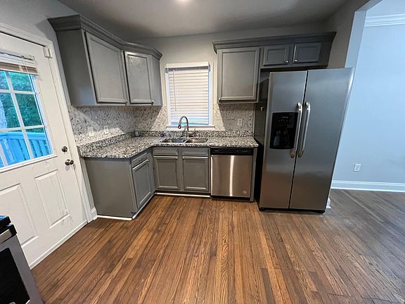 Kitchen area includes granite countertops and all stainless steel appliances.