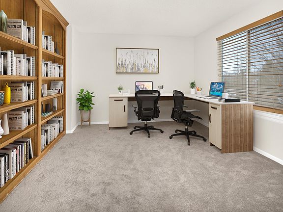 Office with built in bookshelves adjoins the master bedroom and looks over the backyard