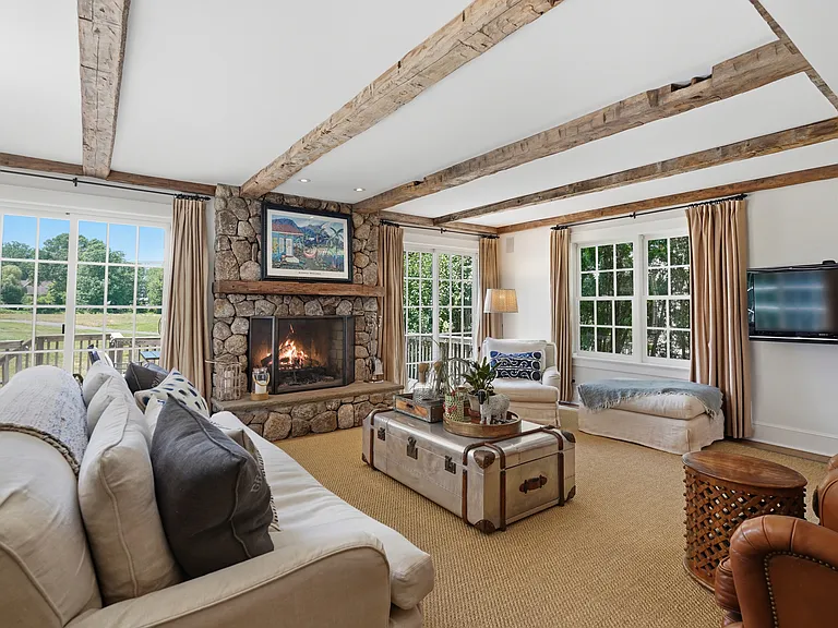 Family Room with Stone Fireplace, French Doors and Beamed Ceiling