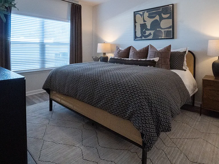 Primary bedroom with king size bed and large window.