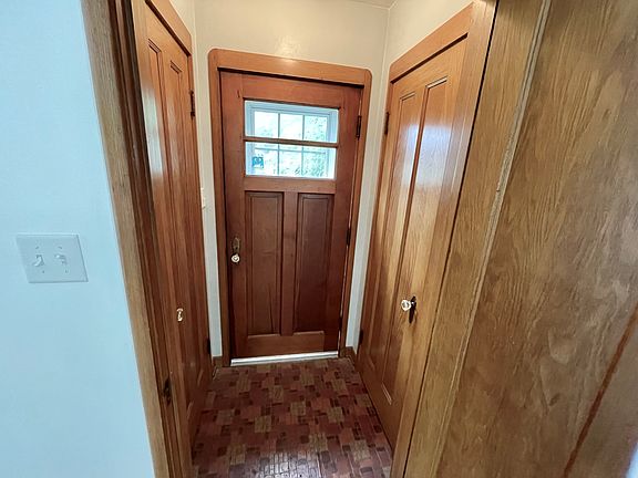 Entryway with two closets for storage.