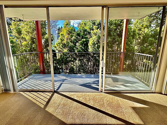 Unit #306 living room balcony with incredible tree VIEWS!