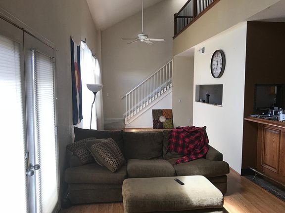 REVERSE VIEW OF LIVING ROOM; STAIRCASE LEADING UPSTAIRS TO M