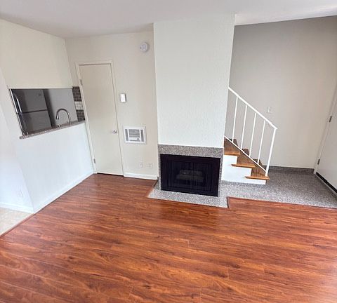 Living room and gas fireplace. Kitchen and breakfast nook are located to the left.