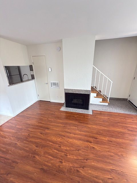 Living room and gas fireplace. Kitchen and breakfast nook are located to the left.