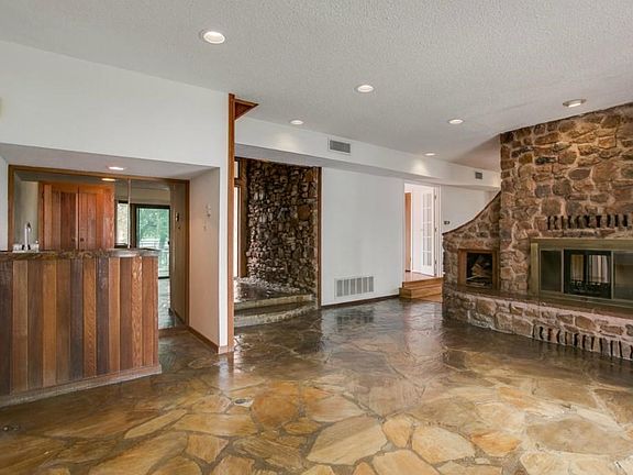 View of Living area, Entry and See Thru Fire place. All Natural Stone throughout