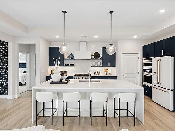 Kitchen with pendant lighting and floating shelves