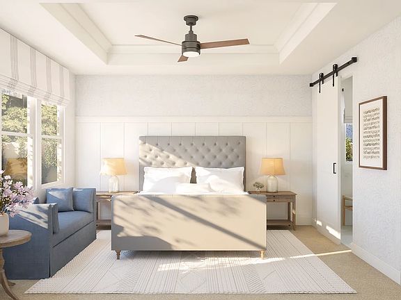 Primary suite with tray ceiling and decorative feature wall