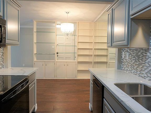 View of kitchen looking into dining area and all the great built-ins that separate the dining area from the foyer.