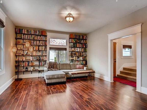 Living room with built-in bookcases and hardwood floors