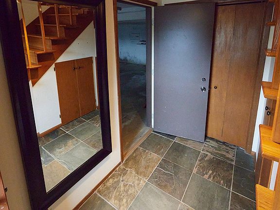 Under staircase storage and entry closet. Attached garage