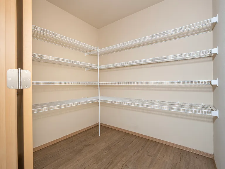 Explore this ample walk-in with modern shelving. Explore this ample walk-in with modern shelving.