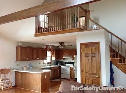 Kitchen and view toward loft
						:
						20 ft ceiling, stone fireplace floor to ceiling