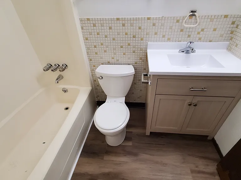 Clean, Bright, Bathroom, with Brand New Vanity, Sink, Faucet, and Luxury Vinyl Plank Flooring
