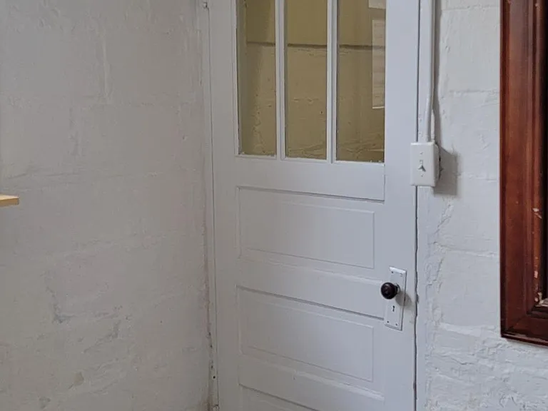 Door at the bottom of the steps to close off the laundry room