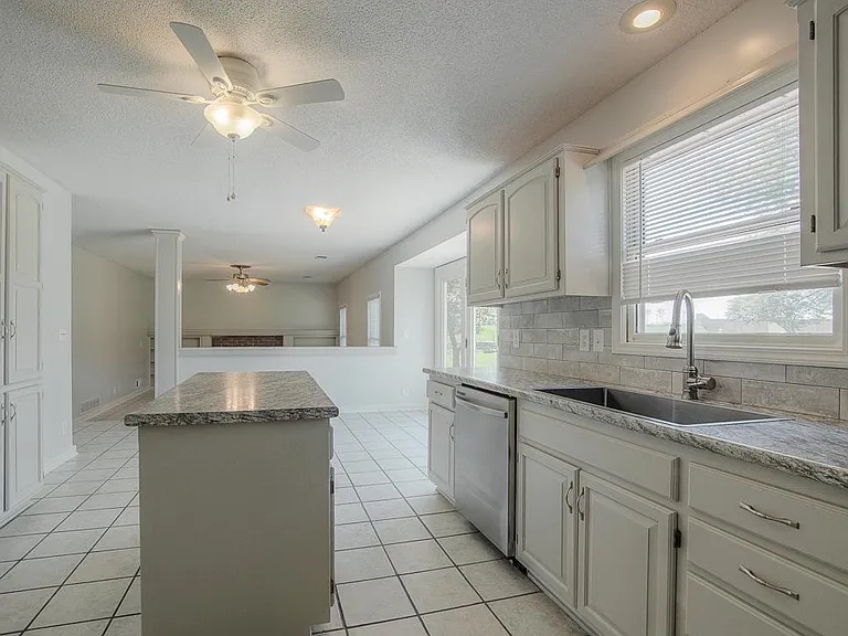 The open kitchen has views of the gorgeous lawn and easy flow from the sunny breakfast area into the family room.