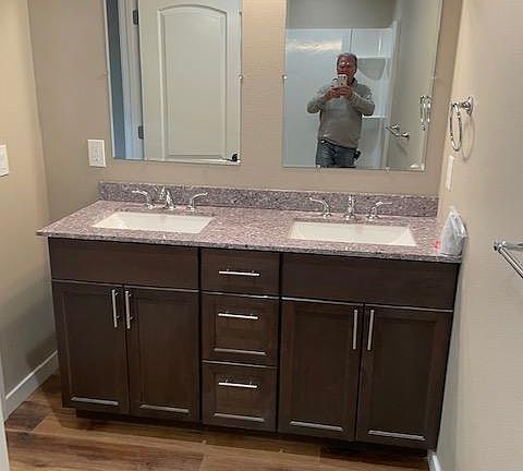 Master bedroom with double sinks in bathroom