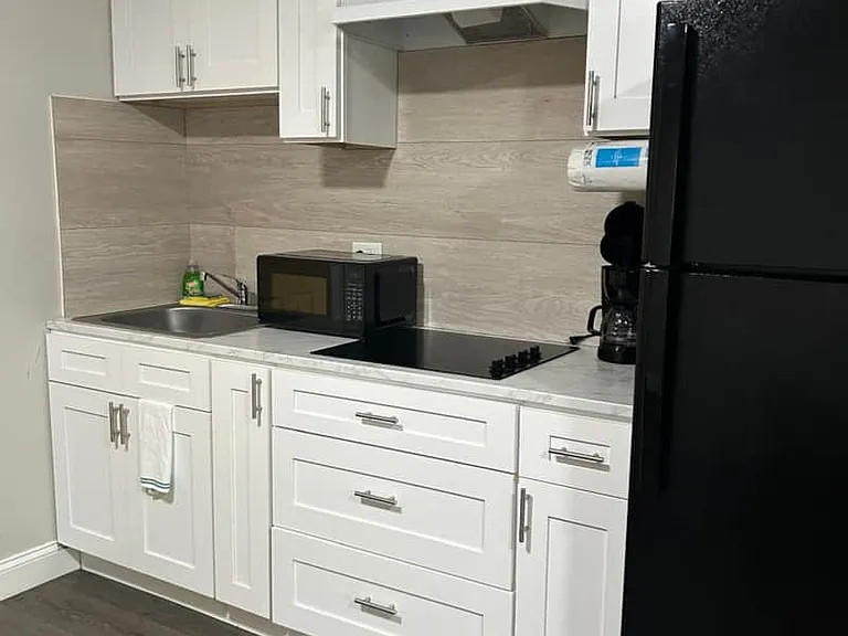Functional kitchen with stove and stocked cabinets