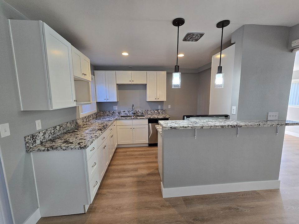 Beautiful new kitchen with dishwasher, new cabinets and custom granite counters