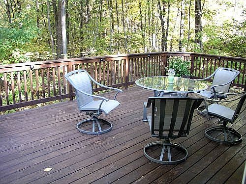 The large deck is shaded by the woods most of the summer day.