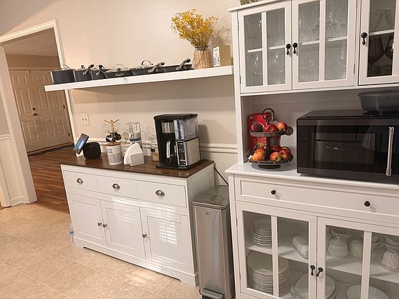 Large kitchen with screen porch and deck overlooking the fenced backyard